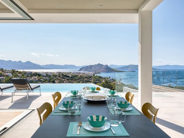 The shaded al fresco dining area at Aeacus, looking over the pool and the sea.